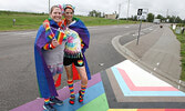 Kaitlin Sanders (right) with partner Amey Legere pose for a photo with the new rainbow crosswalk at the Town Beach.   Tim Brody / Bulletin Photo