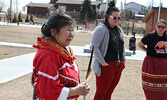 Elder Romaine Lyon (left) leads the Red Dress Day commemorative ceremony.   Tim Brody / Bulletin Photo