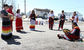 Elder Romaine Wesley (seated) leads the Red Dress Day event outside the SWAC office.   Tim Brody / Bulletin Photo