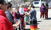 Cindy Phillips pours water for participants as part of a water ceremony held during the event.   Tim Brody / Bulletin Photo