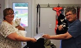 Rotary Club of Sioux Lookout representative Susan Barclay (right) presents a cheque to Sioux Looks Out for Paws animal rescue representative Lynda Ducharme. Both cats Barclay and Ducharme are holding were up for adoption as of the time this photo was take