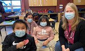 Sioux Mountain Public School staff members Kailey Clarke (back) and Tricia Wilson (front right) show their support of Pink Shirt Day with students Ziggy Winter (front left) and Emerson Sugarhead (centre).    Sioux Mountain Public School / Submitted Photo