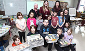 Tallie MacDonald’s Grade 1/2 class show off the boxes of cookies they baked as a fundraiser for Sioux Looks Out For Paws. - Tim Brody / Bulletin Photo