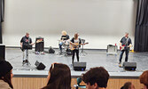 Chelsea Young (Centre), with supporting act Rudy Strangling Wolf (Right), play music for students in the cafetorium, inspiring youth to follow their dreams.   Andre Gomelyuk / Bulletin Photo