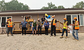 Dignitaries officially open SLAAMB’s second duplex on August 3. Centre from left: Kitchenuhmaykoosib Inninuwug First Nation Chief Donnie Morris, SLAAMB Chair and KFTC Board Member Jim Robinson, Sioux Lookout Mayor Doug Lawrance and SLAAMB Coordinator Mary