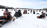 Second place winner Mark Ridgway (seated on snowmobile far left) was one of more than 120 anglers who took part in the fishing derby. - Tim Brody / Bulletin Photo