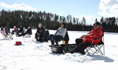 Freeman Ningewance (far right) and his sister Trudy Quoquat (seated beside him) enjoy the fishing derby.   Tim Brody / Bulletin Photo