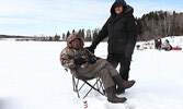 Sixth place winner Roy Carpenter (seated) enjoys the beautiful day on the lake with his wife Wilma Carpenter. - Tim Brody / Bulletin Photo