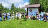 SLFNHA gathered all present for a photo with their new sign marking the opening of their cultural centre, Omamun Ziibiis, located on Highway 664.   Mike Lawrence / Bulletin Photo