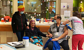 ECU resident Eunice Fiddler (second from left) offers her support to SLMHC Interpreter Tom Chapman (second from right), who was the first SLMHC staff member to receive the COVID-19 Moderna vaccine. Fiddler’s daughter Margaret Beardy (standing, far left) w