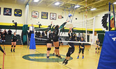 The SNHS Warriors senior girls’ volleyball team attempt to block a floating volley during a home game against the PFFNHS Timberwolves last year. - Jesse Bonello / Bulletin Photo