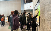 SNHS teacher Nicole Carbone (pointing at poster), speaks with students at the SNHS Course Fair.   Tim Brody / Bulletin Photo