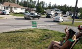 Graduate Hannah Smith waves to parade participants.     Tim Brody / Bulletin Photo