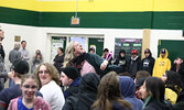 Sioux North High School teacher Kristi Pianka enthusiastically tosses SNHS t-shirts to students in celebration of the moving day announcement. - Tim Brody / Bulletin Photo