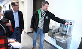Monteith shows off one of the new high school’s water bottle filling stations, an addition to the school which earned a round of applause from students who got to view some photos of the new school during their assembly. - Tim Brody / Bulletin Photo