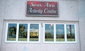 Advice from a sunflower, painted on the Front Street facing windows of the Sioux Area Senior Activity Centre, created by Charron Sippola and her helpers. - Tim Brody / Bulletin Photo