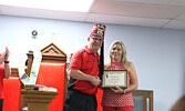 Fresh Market Foods co-owner Tracey Bullock (right) accepts a certificate of appreciation from Potentate Denis Lorteau.