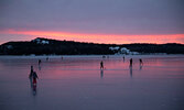 Skaters take to the glassy surface of Pelican Lake at sunset. - Sylvia Drew \ Submitted Photo