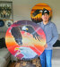 Artist Nathan Monias displays his art. The piece on the left depicting three timber wolves is titled “The Hunt”, while the piece on the right depicting two bald eagles is titled “Above the Clouds”.      Mike Lawrence/Bulletin Photos