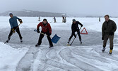 From left: Friends Aaron Rothstein, Ruben Hummelen, Brody Marshall and Sam Loud prepare for a hockey match after clearing the rink in front of Hummelen’s Government Row home, which is connected to the Sioux Lookout Skating Trail. - Tim Brody / Bulletin Ph