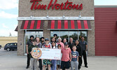 Friends of Cedar Bay board members and Sioux Lookout Tim Hortons staff are joined by community members in unveiling the total for this year’s Smile Cookie campaign in Sioux Lookout. Tim Brody / Bulletin Photo