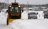 A Municipal employee removes snow from the sidewalk on Front Street in 2005. The municipality maintains 12.5 kilometres of sidewalk within urban Sioux Lookout. - Bulletin File Photo
