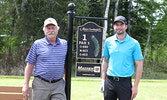 Niels Madsen (left) and son John Madsen of Madsen GM with the Hole #1 sign their business sponsored.  The Madsen GM team took top spot in the tournament put on to thank sponsors for their contributions to the club.      Tim Brody / Bulletin Photo