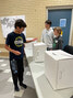 Scared Heart student Marcus Daniels casts his ballot as Dawson Suprovich (R) and Christopher McCord (L) look on during the Student Vote Ontario 2022 event. Students across the province were able to experience the voting process while learning how Canada’s