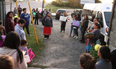 Take Back the Night participants listen to hand drummers outside of the Nishnawbe-Gamik Friendship Centre. - Tim Brody / Bulletin Photos