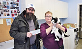 From left: Garett Cosco presenting Lynda Ducharme, Sioux Looks Out For Paws board chair, with their donation.  - Jesse Bonello / Bulletin Photo