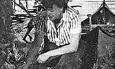 Nan (Dorland) Morenus kneeling beside a canoe.     Source: Maclean’s, August 15, 1947.