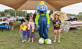 Theatre in the Park participants pose for a photo with Blueberry Festival mascot Blueberry Bert.     Reeti Meenakshi Rohilla / Bulletin Photos