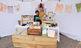 Boston Zaffino (left) helping his mother Sam Carson (right), to sell her products from Sunstone Lifestyle at the Outdoor Home, Craft and Trade Show. 