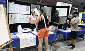 Trade show visitors stop by the Municipality of Sioux Lookout’s information booth.   Tim Brody / Bulletin Photo