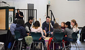 Sioux Mountain Public School students joined Eric Anderson (middle) and Victor Lyon during drumming at the Treaties Recognition Week opening ceremonies at SNHS. - Jesse Bonello / Bulletin Photos