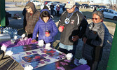 Lac Seul First Nation Chief Derek Maud (second from right) takes in a memorial tribute to the fire victims at the vigil. He expressed his support for the community of KI at the event.  - Tim Brody / Bulletin Photo