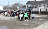 Students marched through town with protest signs during their walkout.  - Tim Brody / Bulletin Photo