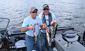 Dave Button (left) and Ernie Seguin with their day one catches, which totaled 6.11 pounds. - Jesse Bonello / Bulletin Photo