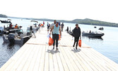 Anglers Chuck Houtz, Karla Madsen, and BJ Egerter (behind) make their way to the weigh in station.   Tim Brody / Bulletin Photo