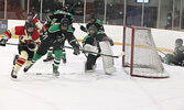 Keenan Fontaine (#16) rushes to clear the puck from the Warriors end of the ice while Warriors goalie Zac Lance keeps a watchful eye on the play.     Tim Brody / Bulletin Photo