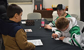 Ben Martin (4) and Kendall Schulz (back right) signed autographs for some of their youngest fans during the meet and greet. - Jesse Bonello / Bulletin Photo