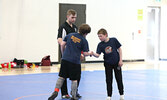Warriors Wrestling Club coach Levi Melnichuk looks on as wrestlers Ethan McCord (left) and Sam Pierce shake hands leading up to their match. - Tim Brody / Bulletin Photo