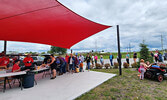 A long, fast moving line for the Sioux Lookout Shrine Club’s famous cone fries and burgers.   Angela Anderson / Bulletin Photo